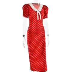 Red polka dot dress with white collar on a mannequin against a white background