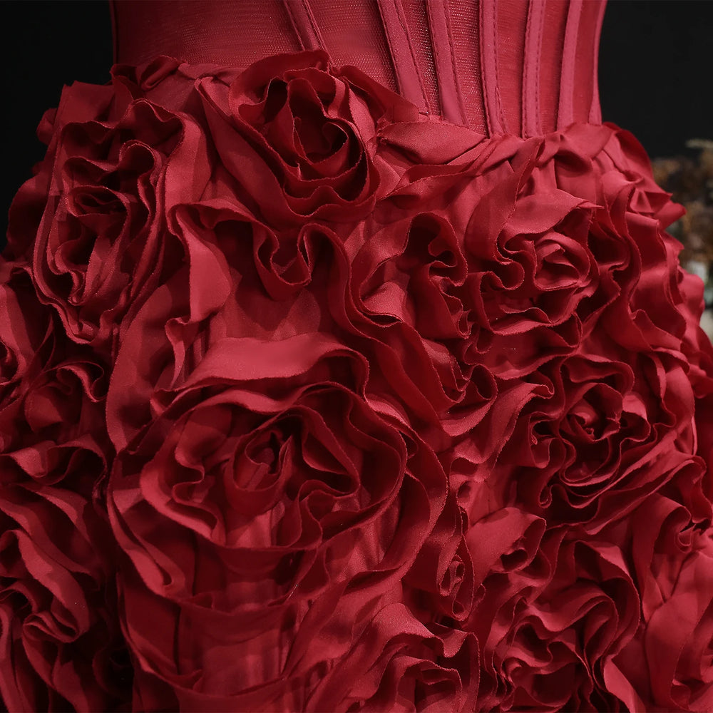 Close-up of a red dress with ruffled details on a dark background