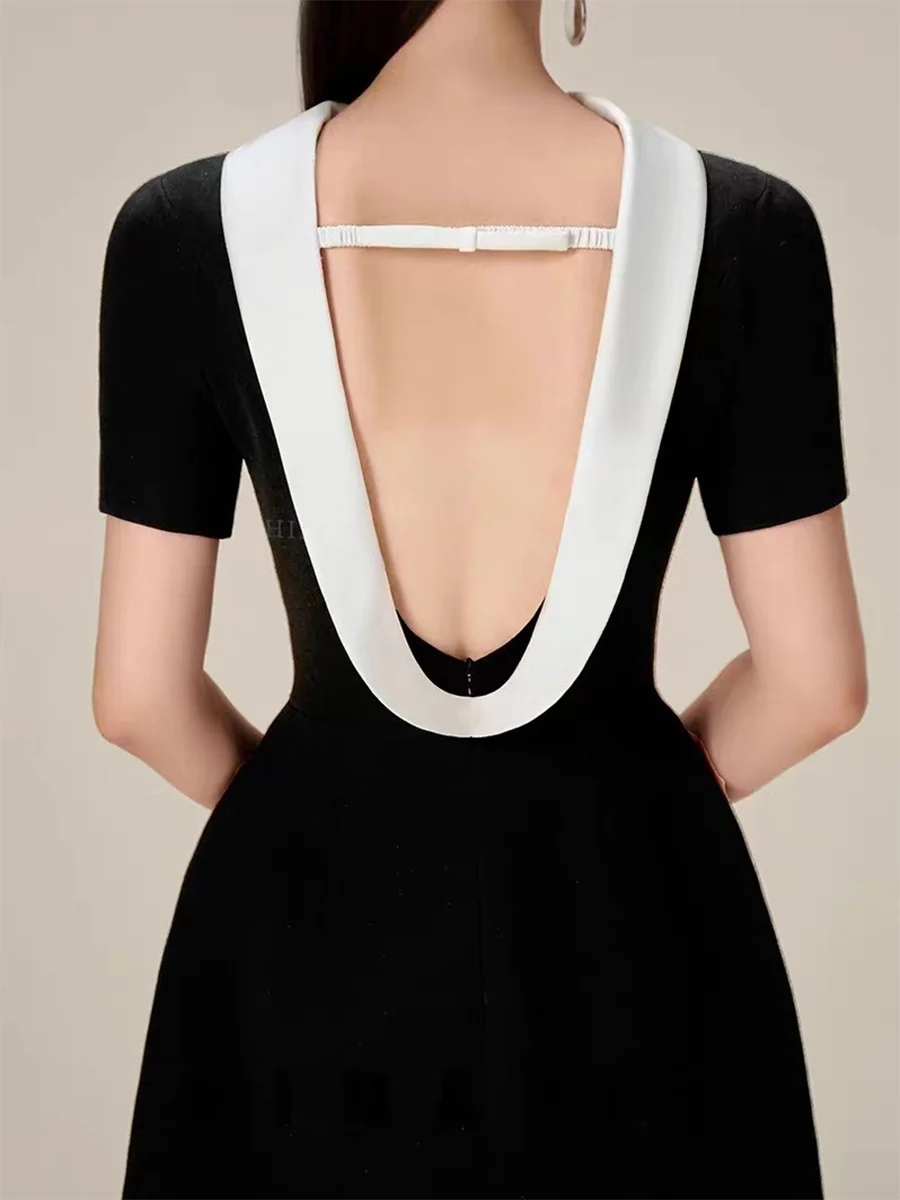 Black dress with a white neckline on a neutral background