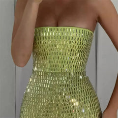 Green strapless dress with sequin detailing on a plain background