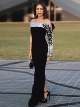 Woman wearing a black and white patterned dress on a blurred outdoor background