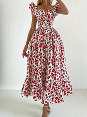 Woman wearing a red and white floral dress on a white background