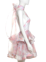 Mannequin wearing a pink floral dress with a sheer overlay on a white background