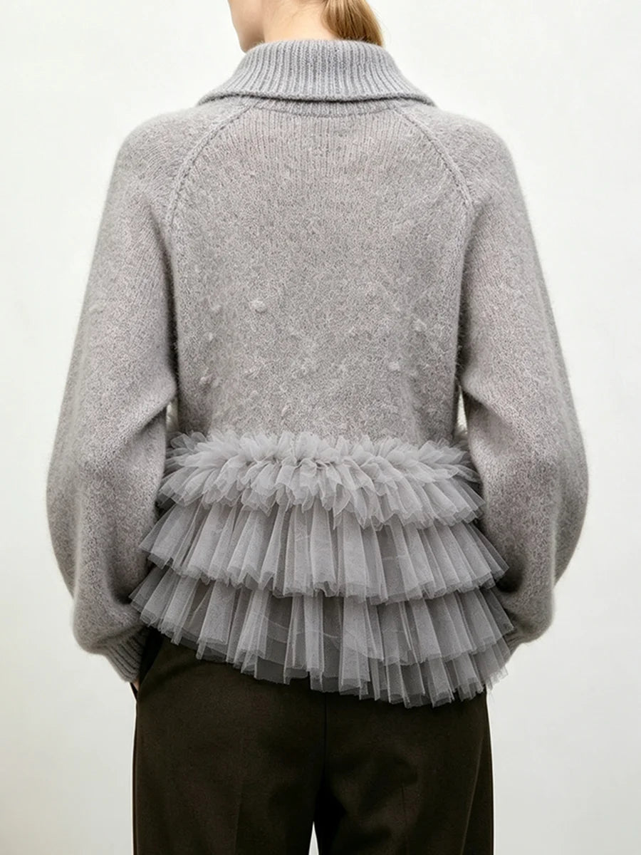 Gray knit sweater with a structured collar and a layered gray tulle ruffle detail at the waist, shown from the back.