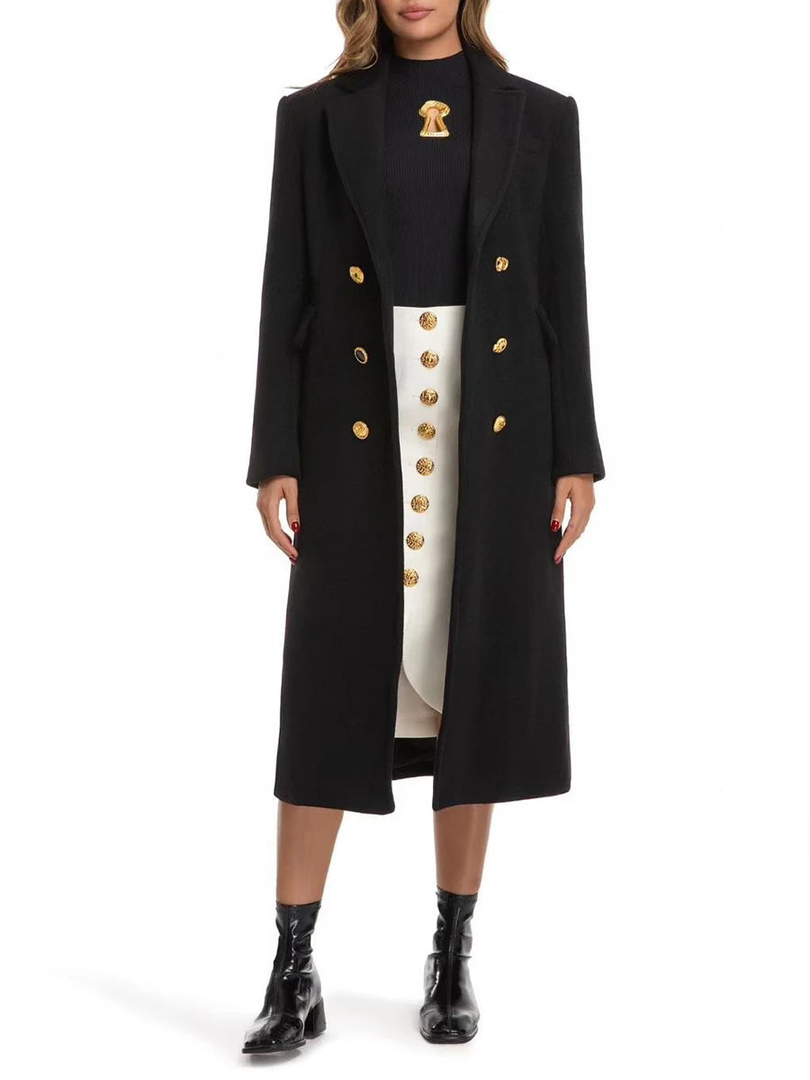 Person wearing a black coat with gold buttons and a white dress underneath