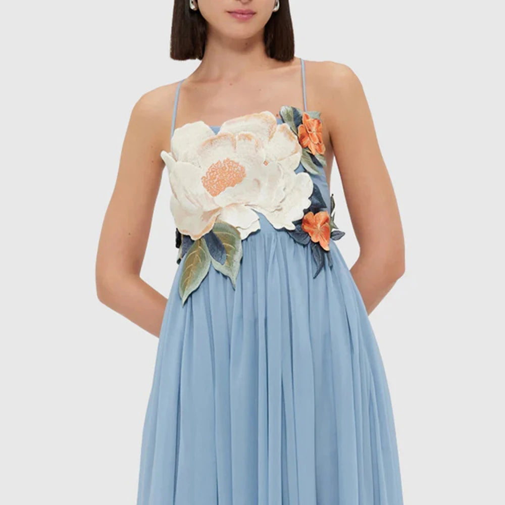 Blue dress with floral embellishments on a white background