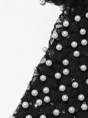 Black tulle fabric with white pearls on a white background