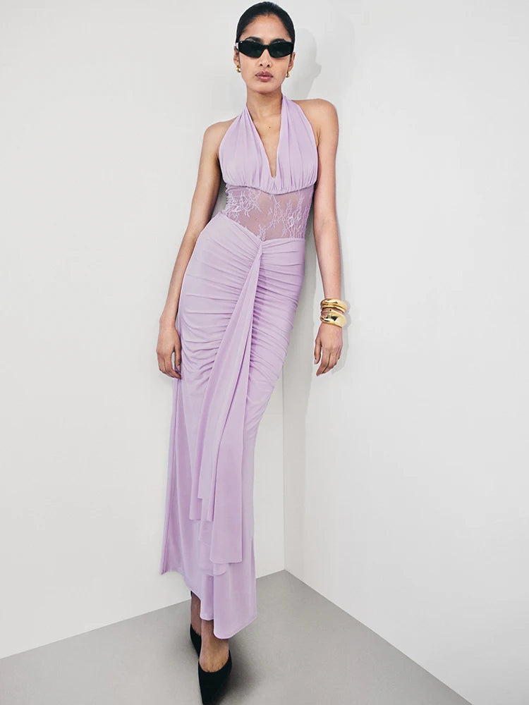 Woman wearing a lavender dress with sheer panels on a white background