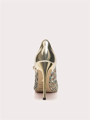 Gold high-heeled shoe with embellishments on a light gray background