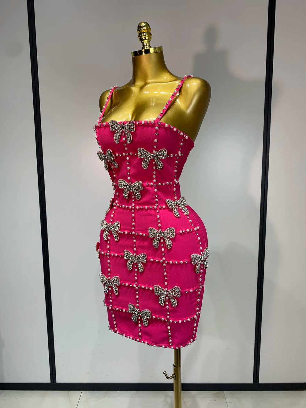 Side view of sleeveless beaded bow mini dress