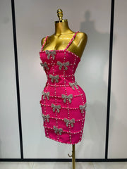Side view of sleeveless beaded bow mini dress