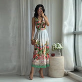 Woman in floral print V-neck sleeveless crop top and floral print pleated A-line midi skirt.