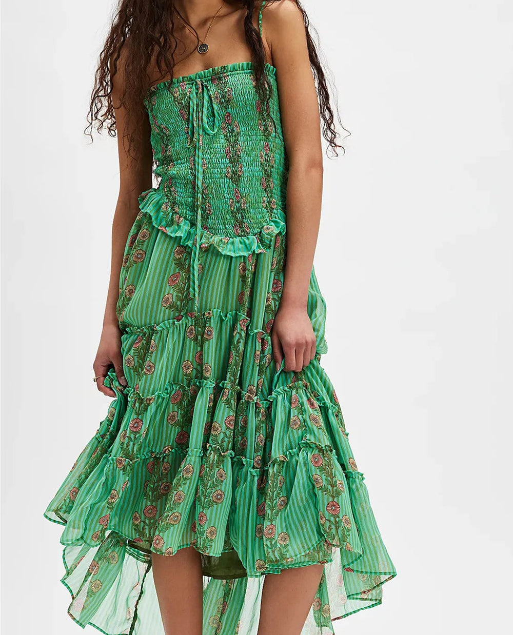 Green floral dress worn by a model on a white background