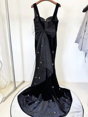 Black velvet mermaid maxi dress with spaghetti straps and beaded embellishments, back detail with bow.