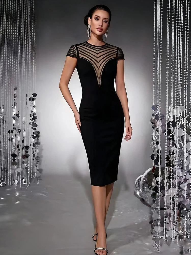 Black sheath midi dress with a sheer mesh yoke featuring chevron beading and cap sleeves, front view.