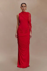 Woman wearing a red evening gown against a beige background
