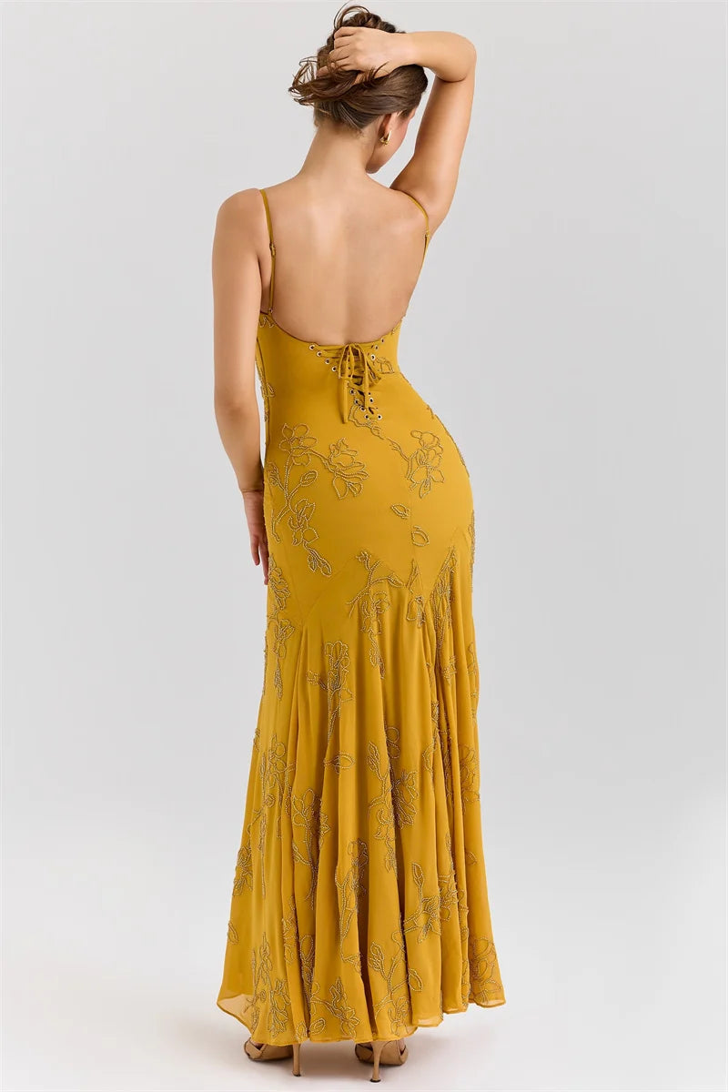 Yellow floral dress with open back on a white background