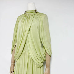 Light green dress on a mannequin against a white background