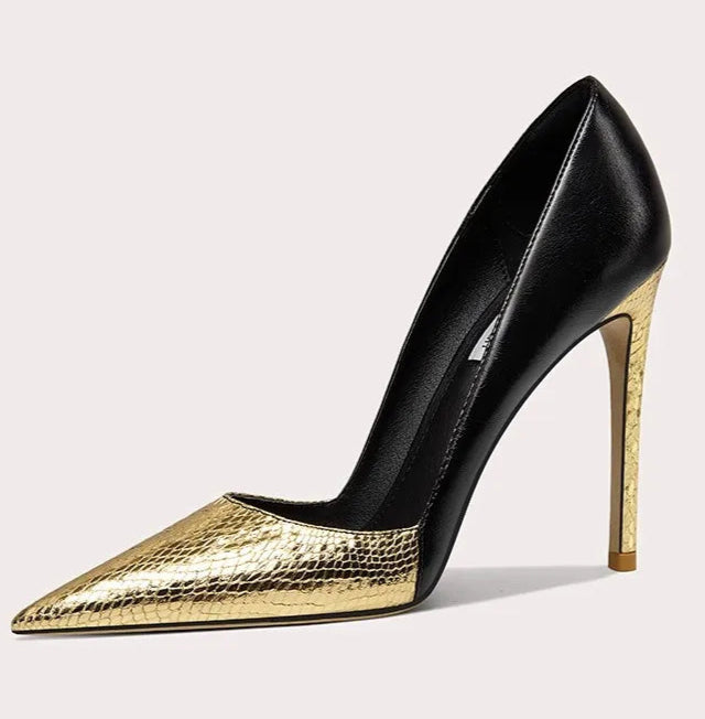 Black and gold high-heeled shoe on a light gray background