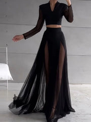 Black outfit with sheer long skirt in a minimalistic setting