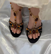 Beaded embellished t-strap stiletto heels on a white satin background