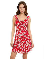 Model wearing a red cherry print mini dress with ruffle straps and a tie V-neck.