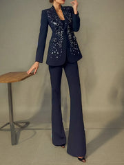 Woman wearing a black beaded blazer suit set indoors