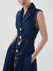 Blue denim dress with gold buttons and belt on a white background
