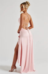 Pink dress with strappy back and high slit on a white background
