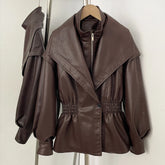 Brown faux leather jacket with cinched waist and high neck detail.