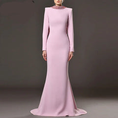 Pink evening gown with long sleeves on a gray background, featuring the brand QMQA.
