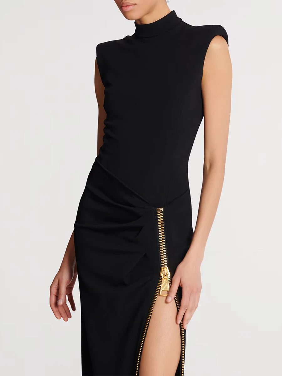 Black dress with a gold zipper on a white background