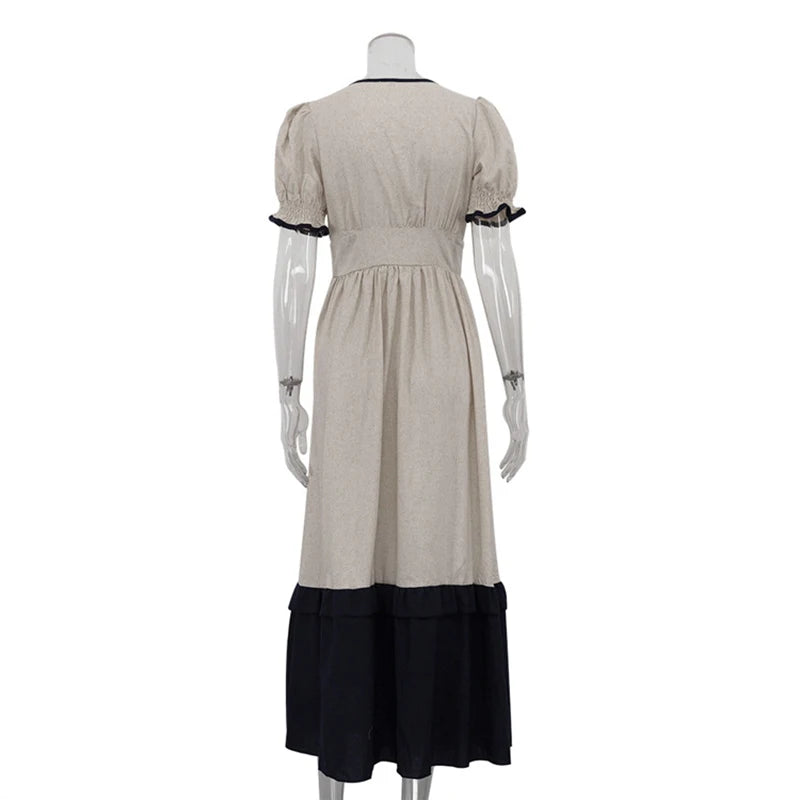 Mannequin wearing a beige dress with black trim on a white background