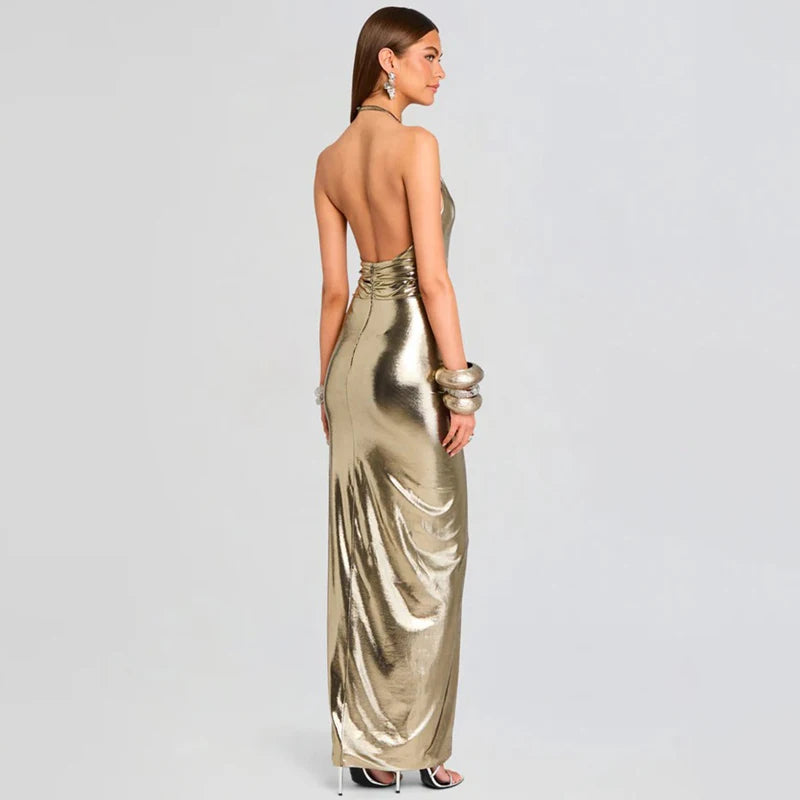 Woman wearing a gold metallic dress on a light gray background