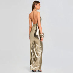 Woman wearing a gold metallic dress on a light gray background