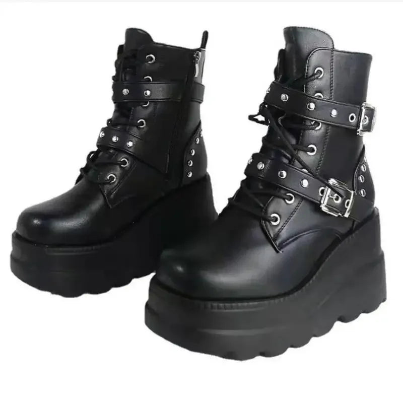 Black leather boots with buckles on a white background