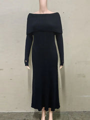 Black ribbed dress on a mannequin against a plain background