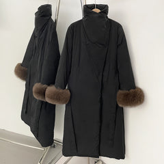 Black coat with fur cuffs on a mannequin against a white background
