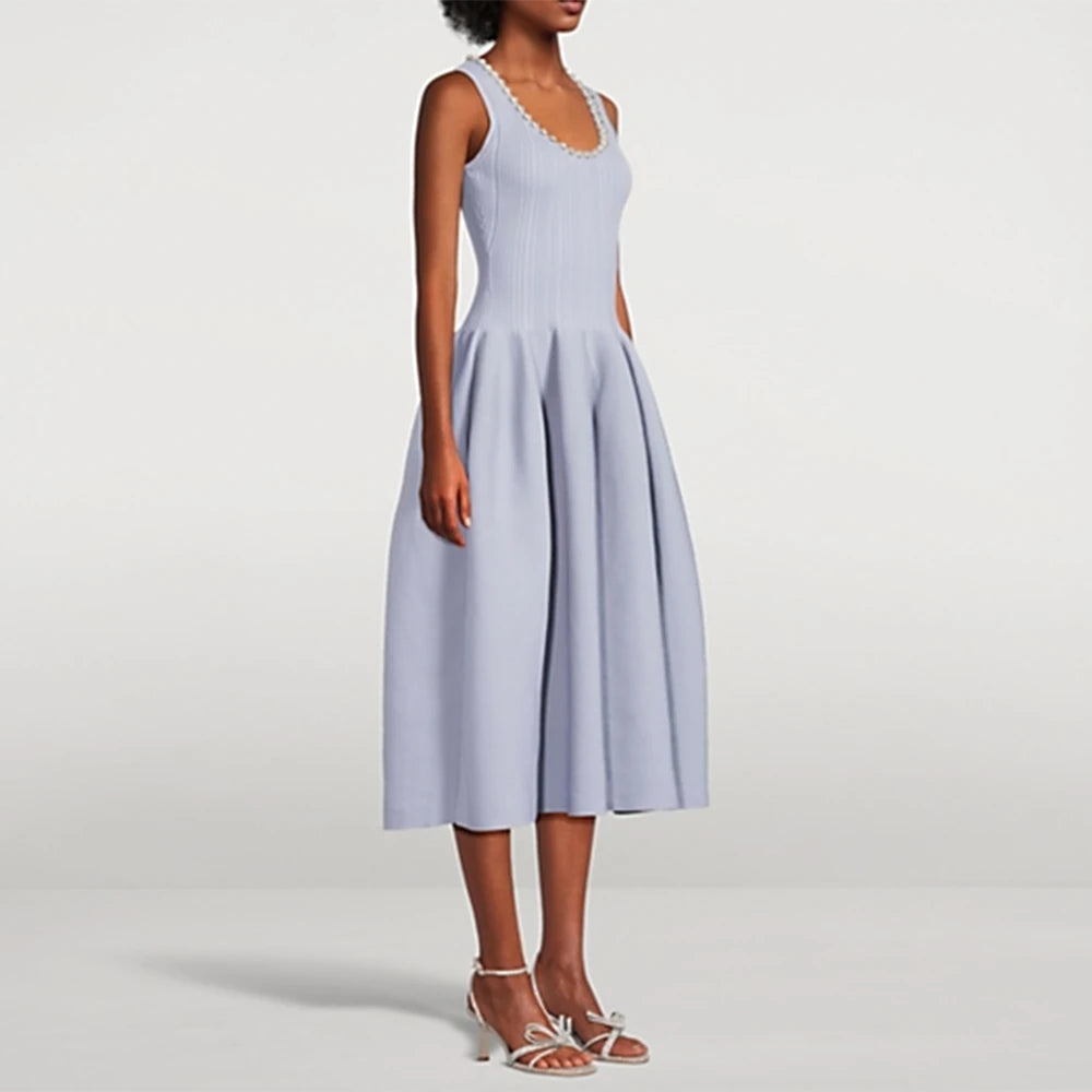 Woman wearing a light blue dress on a white background