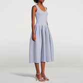 Woman wearing a light blue dress on a white background