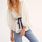 White puff sleeve lace trim peplum top with navy tie
