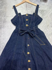 Close-up of denim midi dress bodice with button front and belt