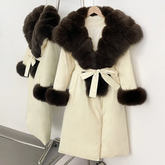Beige coat with dark fur trim on a white background