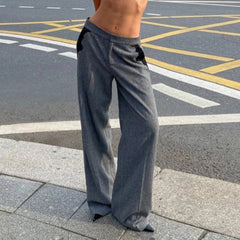 Person wearing gray wide-leg pants on a street
