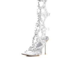Clear high-heeled shoe with decorative elements