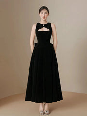 Woman wearing a black evening gown against a beige background