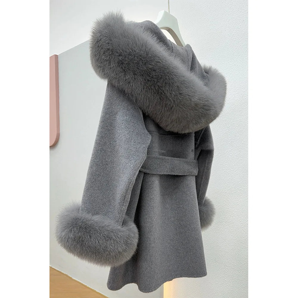 Gray coat with fur trim on a hanger against a white background
