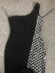 Black dress with geometric pattern on a gray surface