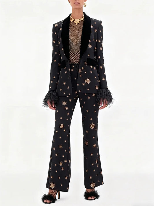 Model wearing a black star embroidered blazer with feather cuffs and matching flare pants.