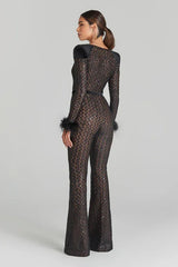 Woman wearing a leopard print outfit with feathered sleeves on a gray background